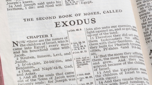 A Bible opened to the book of Exodus.