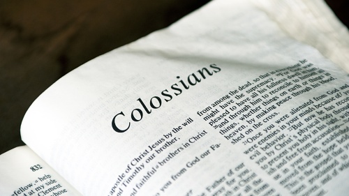 A Bible opened to book of Colossians. 