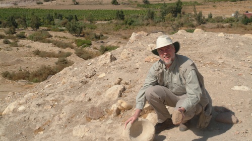 The author examines a stone grinder and bowl at Tall el-Hammam before excavations began.