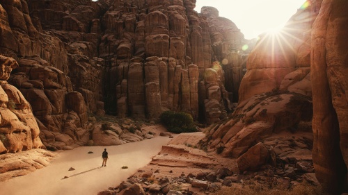 A man walking in the desert.
