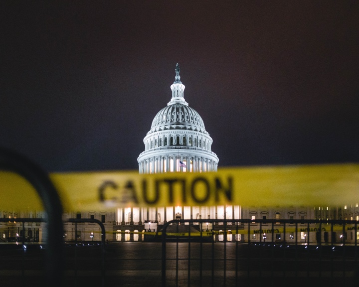 Photo of the U.S. Capitol in the background with caution tape in the foreground.